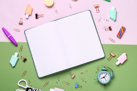 Notebook with different stationery supplies on colorful backgroundの写真素材