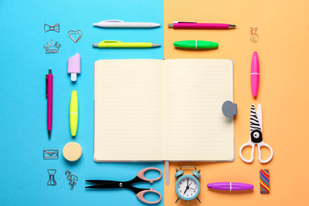 Notebook with different stationery supplies on colorful backgroundの写真素材