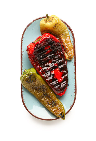 Plate with different grilled peppers on white backgroundの写真素材