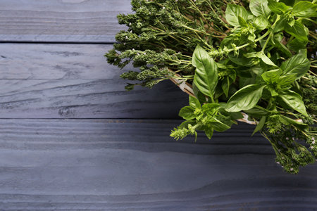 Basket with fresh herbs on dark color backgroundの写真素材