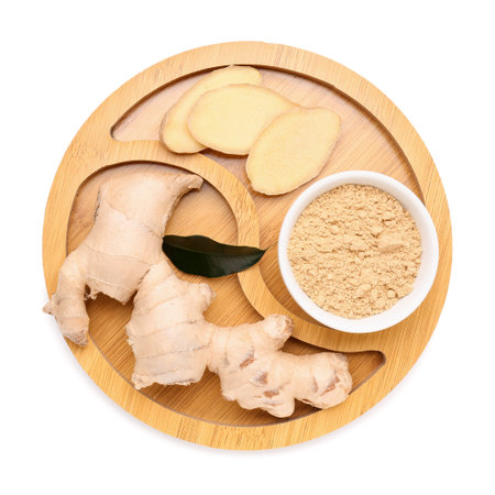 Wooden board with fresh ginger root and bowl of dried powder on white background