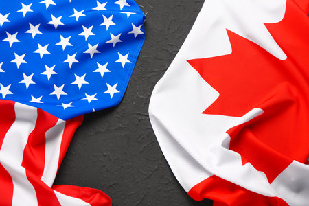 Flags of USA and Canada on black backgroundの写真素材