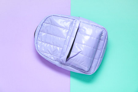 Lilac school backpack on color backgroundの写真素材