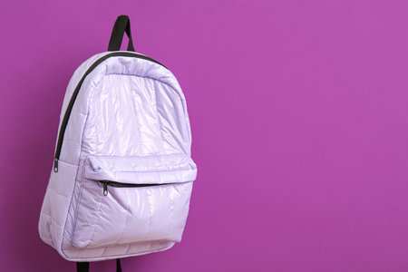 Lilac school backpack on purple backgroundの写真素材