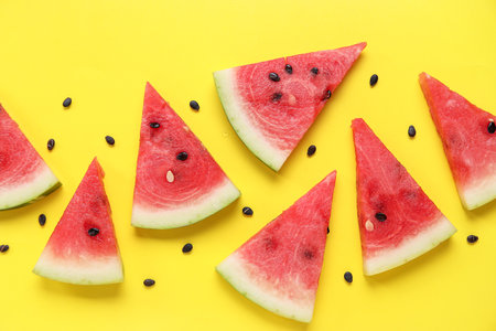 Composition with pieces of ripe watermelon on yellow backgroundの写真素材