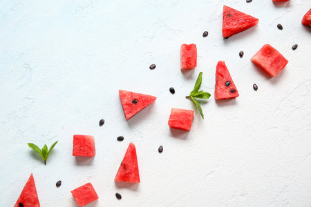 Composition with different pieces of ripe watermelon on light backgroundの写真素材