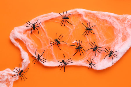 Cobweb with spiders for Halloween party on orange background