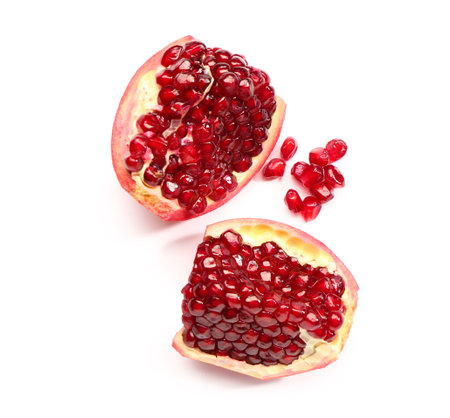 Pieces of fresh pomegranate with seeds on white backgroundの写真素材