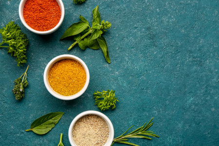 Composition with fresh spices and herbs on color backgroundの写真素材