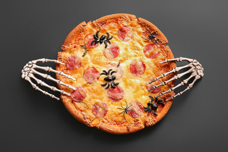 Tasty pizza for Halloween celebration on black backgroundの写真素材