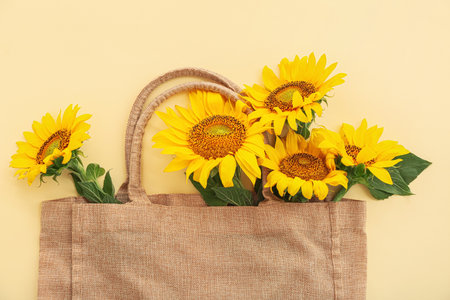 Eco bag with beautiful sunflowers on yellow backgroundの写真素材