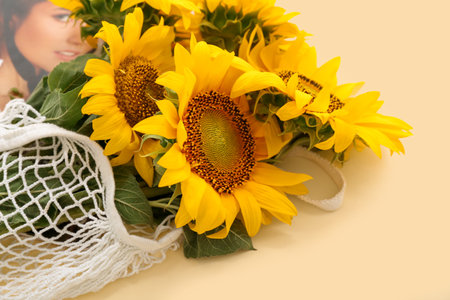 String bag with beautiful sunflowers on yellow backgroundの写真素材
