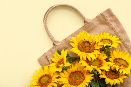 Eco bag with beautiful sunflowers on yellow backgroundの写真素材