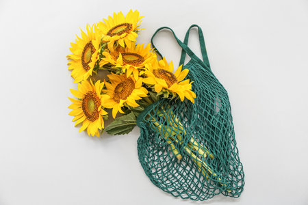 String bag with beautiful sunflowers on gray backgroundの写真素材