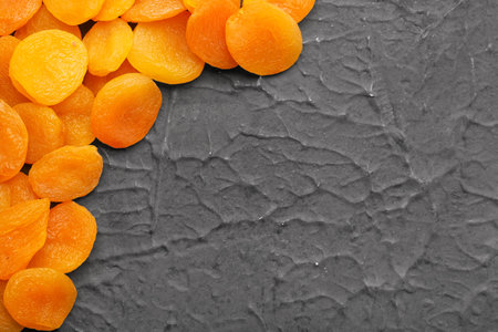 Tasty dried apricots on black backgroundの写真素材