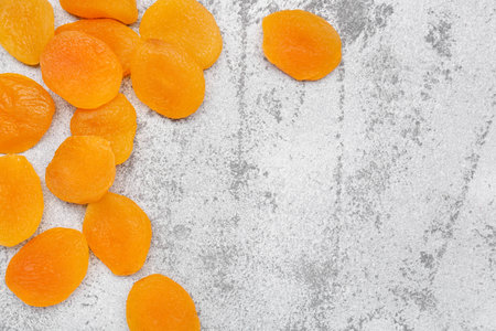 Tasty dried apricots on gray backgroundの写真素材