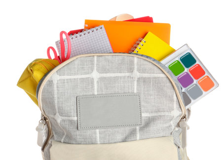 Gray school backpack with notebooks, watercolors and scissors on white backgroundの写真素材