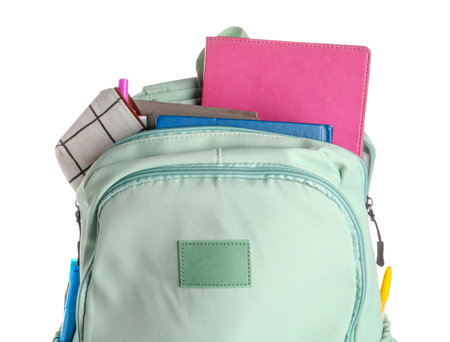 Green school backpack with notebooks and pencils case on white backgroundの写真素材