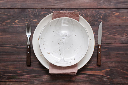 Stylish modern table setting on brown wooden backgroundの写真素材