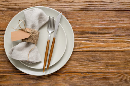 Stylish modern table setting on brown wooden background
