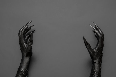 Black hands of witch on gray background. halloween celebrationの写真素材