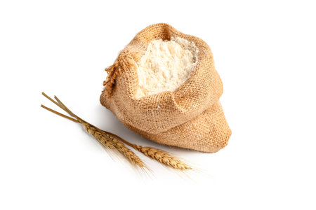 Sack bag with flour and wheat ears on white backgroundの写真素材