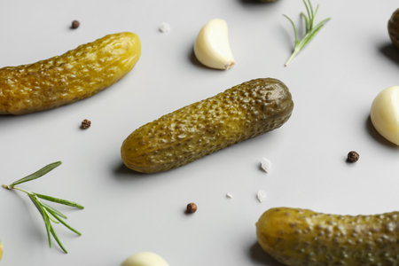 Pickled cucumbers and different spices on gray backgroundの写真素材