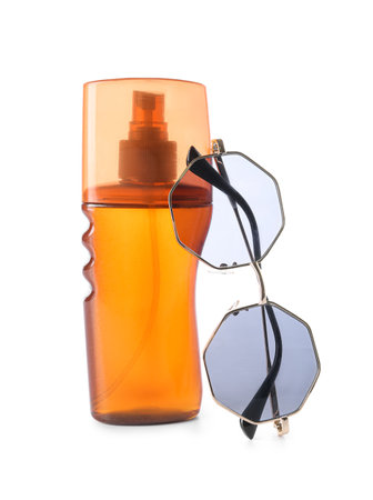 Bottle of sunscreen and stylish sunglasses on white backgroundの写真素材