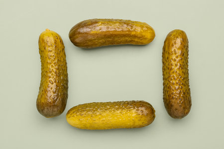 Frame made of pickled cucumbers on green backgroundの写真素材