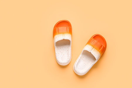 Female stylish flip flops on orange backgroundの写真素材
