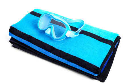 New swimming mask and towel on white background