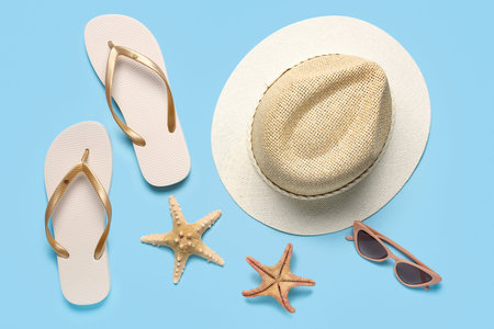 Composition with beach accessories and starfishes on color background