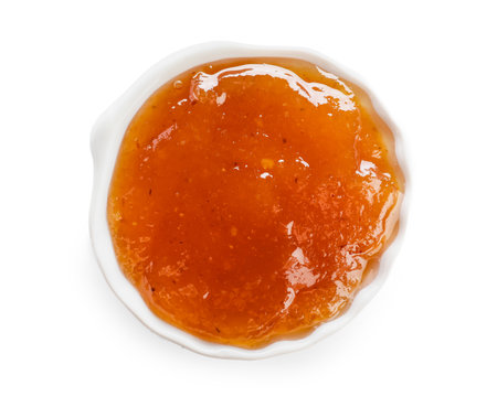 Bowl with sweet apricot jam on white backgroundの写真素材