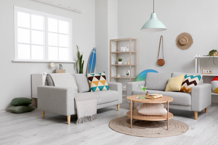 Stylish interior of light living room with beach accessoriesの写真素材