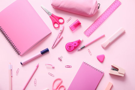Different school stationery and notebooks on pink backgroundの写真素材