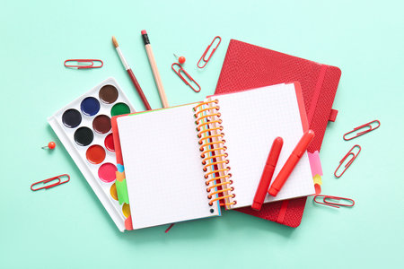 Different school stationery and notebooks on turquoise backgroundの写真素材