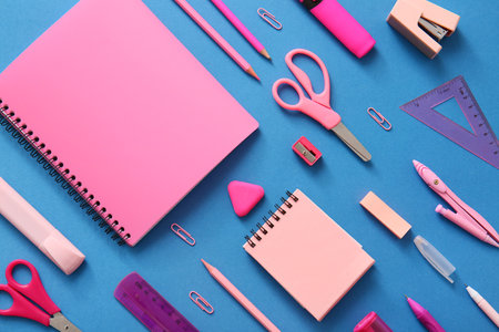 Different school stationery and notebooks on blue backgroundの写真素材