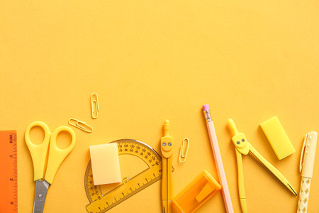 Different school stationery on orange backgroundの写真素材