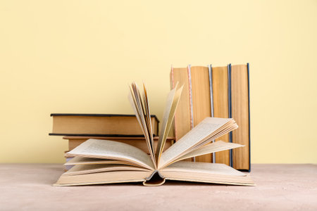 Books on table against beige backgroundの写真素材