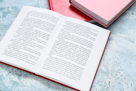 Open book on light blue tableの写真素材