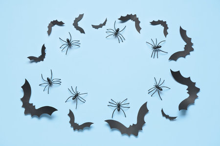 Frame made of paper bats and spiders for Halloween party on blue backgroundの写真素材