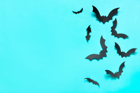 Paper bats for Halloween party on blue background