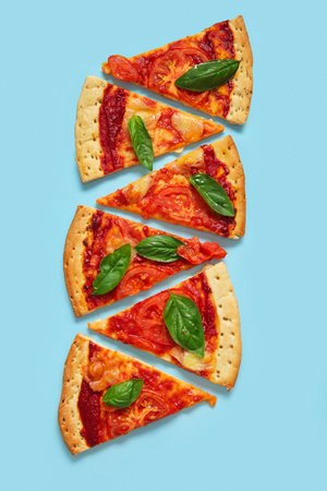 Slices of tasty pizza on blue backgroundの写真素材