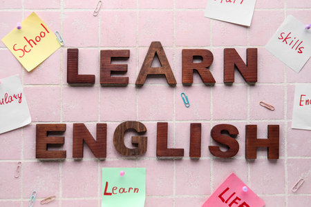 Sticky notes with different words and text LEARN ENGLISH on pink tile background