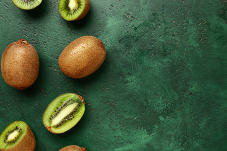 Fresh kiwi on green backgroundの写真素材