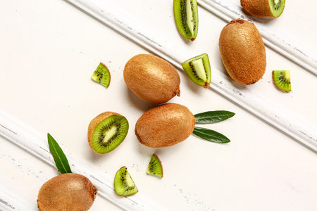 Fresh kiwi and leaves on white backgroundの写真素材