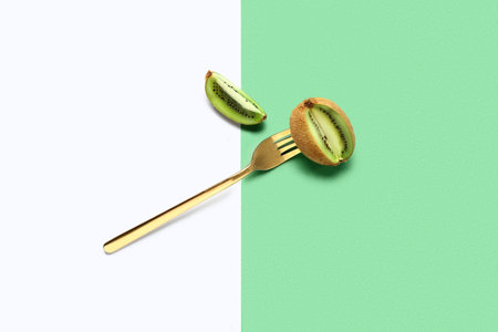 Fork with fresh kiwi on colorful backgroundの写真素材
