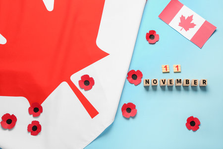 Poppy flowers with flags of Canada and text 11 NOVEMBER on blue background. Remembrance Dayの写真素材