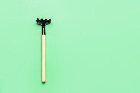 Gardening rake on green backgroundの写真素材