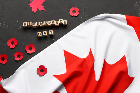 Poppy flowers with flag of Canada on grunge black background. Remembrance Dayの写真素材